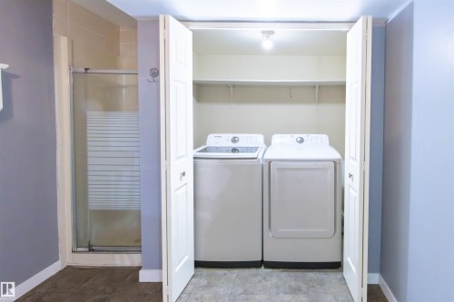 Laundry closet with bi-fold doors and built-in shelving included with bathroom - 4903 11A Avenue Nw, Edmonton, AB - Indoor Photo Showing Laundry Room