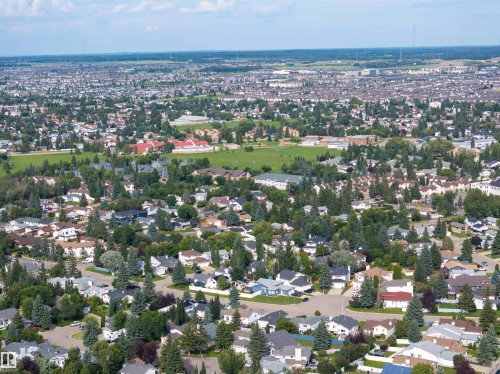 Expansive aerial perspective showcasing a residential development with extensive tree coverage - 4903 11A Avenue Nw, Edmonton, AB - Outdoor With View
