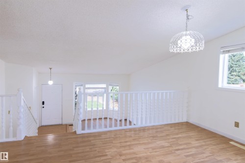 Light wood-finish flooring extending throughout the space - 4903 11A Avenue Nw, Edmonton, AB - Indoor Photo Showing Other Room