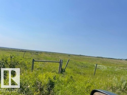 Expansive undeveloped land featuring natural vegetation and partial fencing under a clear sky - Hwy 15 & Rr 185, Rural Lamont County, AB 