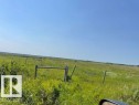 Expansive undeveloped land featuring natural vegetation and partial fencing under a clear sky - Hwy 15 & Rr 185, Rural Lamont County, AB 