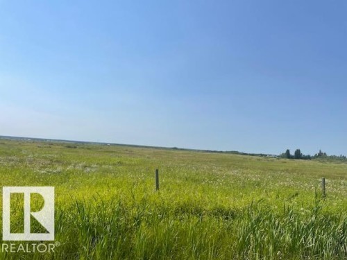Expansive parcel featuring open fields and distant tree lines under a clear sky - Hwy 15 & Rr 185, Rural Lamont County, AB 