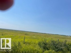 Expansive undeveloped land featuring natural grasses and scattered shrubbery - 
