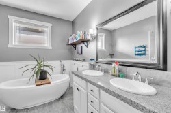 Freestanding soaking tub with floor-mounted faucet - 