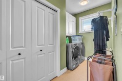 Laundry area featuring built-in cabinetry, a window, and overhead lighting - 