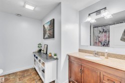 Wood-finish plank flooring complements the white wall tones - 