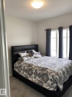 Plush carpeting, bright white walls, and a contemporary ceiling light fixture - 