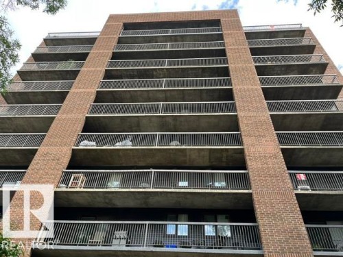 Brick exterior with multiple private balconies featuring metal railings - #202 9929 113 St Nw, Edmonton, AB - Outdoor With Exterior