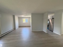Spacious interior featuring light wood-finish flooring, neutral paint, and an open-concept design - 
