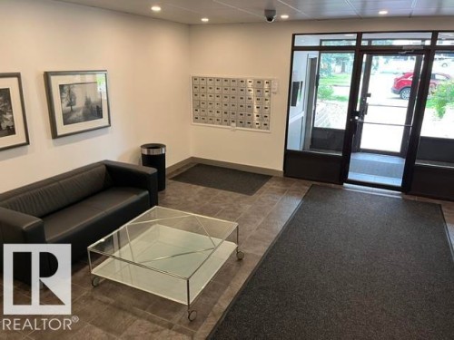 Entryway featuring transom windows, recessed lighting, wall-mounted mailboxes, and neutral floor tile - #202 9929 113 St Nw, Edmonton, AB - Indoor Photo Showing Other Room
