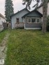 Property exterior featuring stucco siding, an enclosed porch with horizontal paneling, and a wood deck - 12722 116 Street Nw, Edmonton, AB  - Outdoor 
