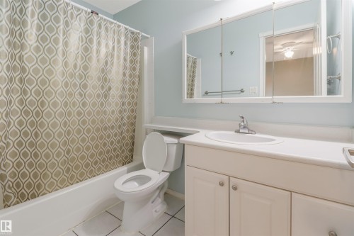 Vanity with integrated sink, white cabinetry, and wall-mounted tri-view medicine cabinet - 1055 Jones Crescent Nw, Edmonton, AB - Indoor Photo Showing Bathroom