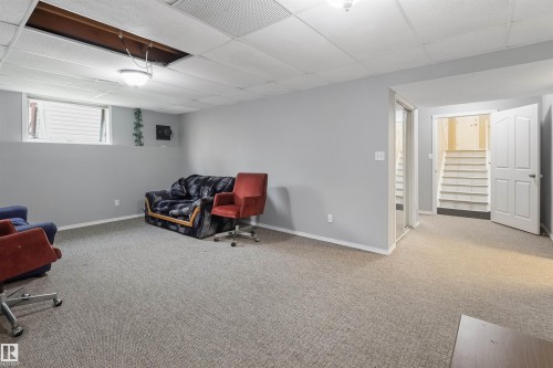 Spacious basement recreation room with neutral carpeting, recessed ceiling lighting, and abundant natural light from high-set windows - 1055 Jones Crescent Nw, Edmonton, AB - Indoor
