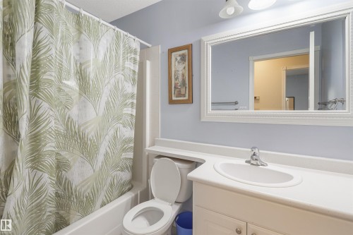 White vanity with integrated sink, chrome faucet, and framed mirror with decorative trim - 1055 Jones Crescent Nw, Edmonton, AB - Indoor Photo Showing Bathroom