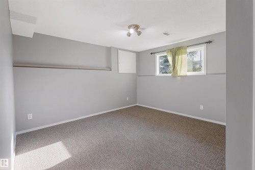 Carpeted flooring, recessed window, ceiling-mounted light fixture, light gray walls - 1055 Jones Crescent Nw, Edmonton, AB - Indoor Photo Showing Other Room