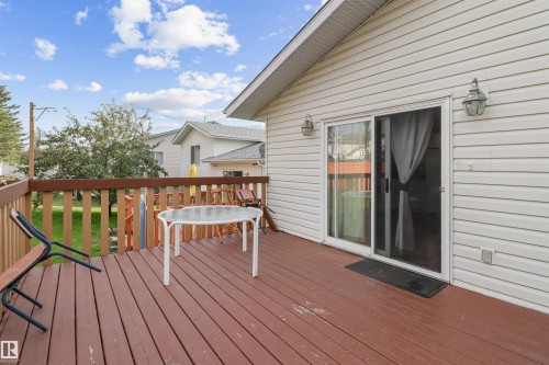 Expansive deck with wood-finish flooring, wood railing, and direct access to interior via sliding glass door - 1055 Jones Crescent Nw, Edmonton, AB - Outdoor With Deck Patio Veranda With Exterior