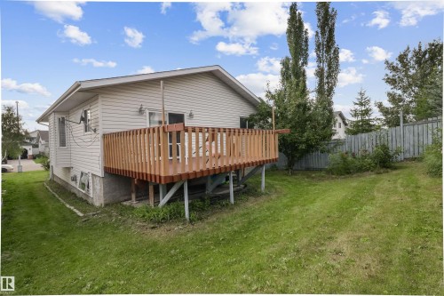 Spacious single-story residence featuring a wood-finish deck with sturdy railings, elevated on a foundation with ample undercarriage clearance - 1055 Jones Crescent Nw, Edmonton, AB - Outdoor With Deck Patio Veranda