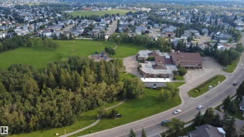 Expansive green spaces featuring mature trees and a playground - 1055 Jones Crescent Nw, Edmonton, AB - Outdoor With View