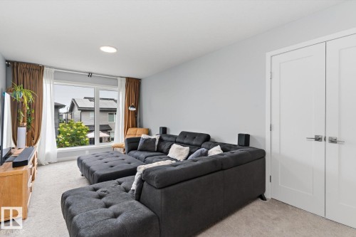 Recessed ceiling lighting, light gray wall finish, white interior doors, and a large window with white framing - 3241 Kulay Way Sw, Edmonton, AB - Indoor