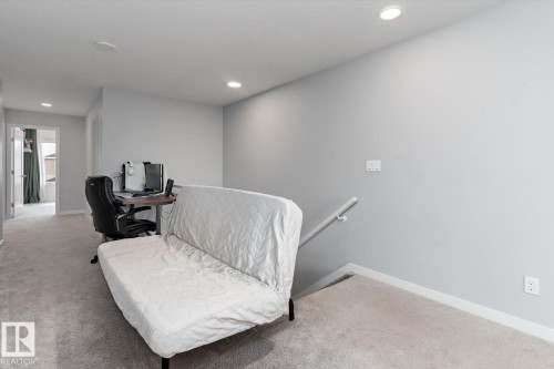 Recessed lighting, carpeted flooring, and a hallway leading to an additional space - 3241 Kulay Way Sw, Edmonton, AB - Indoor