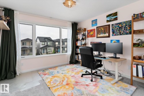 Expansive window with white trim, light-toned wall color, and carpeted flooring - 3241 Kulay Way Sw, Edmonton, AB - Indoor Photo Showing Office