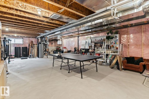 Unfinished basement with exposed ceiling joists, concrete flooring, and visible insulation - 3241 Kulay Way Sw, Edmonton, AB - Indoor Photo Showing Basement