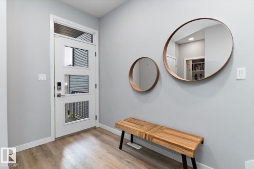 Modern entry door with multiple glass lites and transom - 3241 Kulay Way Sw, Edmonton, AB - Indoor Photo Showing Other Room
