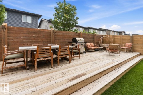 Multi-level wood deck with steps, a full privacy fence, and artificial turf - 3241 Kulay Way Sw, Edmonton, AB - Outdoor With Deck Patio Veranda With Exterior