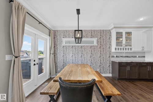 Hardwood-finish flooring extending through the dining area and into the kitchen - 1399 Graydon Hill Way Sw, Edmonton, AB - Indoor