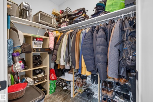 Built-in shelving and hanging rods in a walk-in closet - 1399 Graydon Hill Way Sw, Edmonton, AB - Indoor With Storage