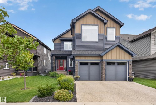 Multi-level exterior with mixed siding, stone accents, and a red entry door - 1399 Graydon Hill Way Sw, Edmonton, AB - Outdoor With Facade