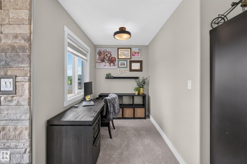 Dedicated workspace featuring a built-in desk with drawer storage, a window with natural light, and recessed shelving - 1399 Graydon Hill Way Sw, Edmonton, AB - Indoor Photo Showing Other Room