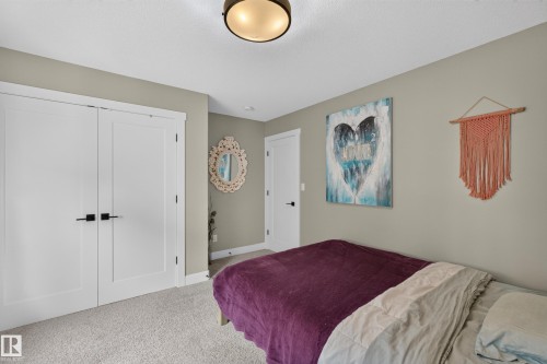 Dual white panel doors with matte black hardware - 1399 Graydon Hill Way Sw, Edmonton, AB - Indoor Photo Showing Bedroom