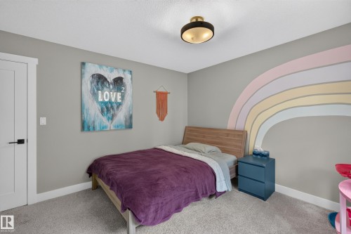 Light gray wall paint, recessed lighting fixture, light wood-finish bed frame, light gray carpeting, white door with black hardware - 1399 Graydon Hill Way Sw, Edmonton, AB - Indoor Photo Showing Bedroom
