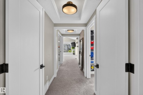 Recessed ceiling with integrated lighting, neutral wall paint, white trim, and light-colored carpeting - 1399 Graydon Hill Way Sw, Edmonton, AB - Indoor Photo Showing Other Room