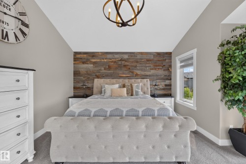 Vaulted ceiling, accent wall with wood-finish paneling, white-trimmed window, and wall-to-wall carpeting - 1399 Graydon Hill Way Sw, Edmonton, AB - Indoor Photo Showing Bedroom