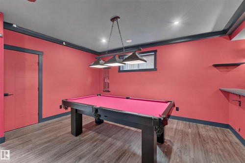 Wood-finish flooring with recessed lighting, crown molding, and a built-in wall shelf - 1399 Graydon Hill Way Sw, Edmonton, AB - Indoor Photo Showing Other Room