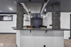 Built-in bar with dark countertop and sink - 
