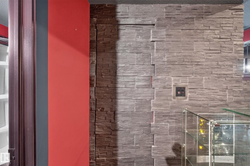 Stone veneer wall treatment and accent wall with rich color - 1399 Graydon Hill Way Sw, Edmonton, AB - Indoor Photo Showing Bathroom
