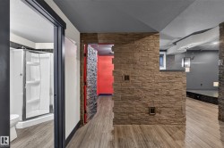 Wood-finish flooring throughout, with a stone veneer accent wall - 