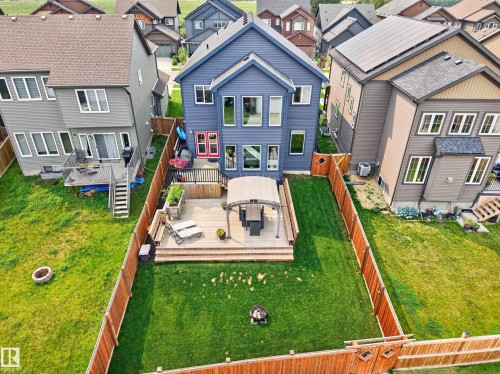 Expansive backyard featuring a manicured lawn, multi-level wood-finish deck, and wood privacy fencing - 1399 Graydon Hill Way Sw, Edmonton, AB - Outdoor With Deck Patio Veranda