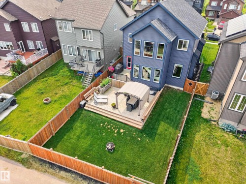 Expansive backyard featuring a manicured lawn, wood fencing, and a multi-level deck with a pergola - 1399 Graydon Hill Way Sw, Edmonton, AB - Outdoor