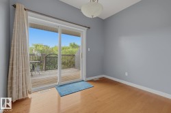 Wood-finish flooring with white trim and light blue walls - 