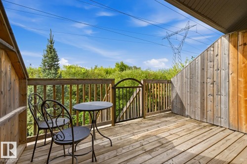 Wood-plank outdoor deck with wood railing and black metal gate - #9 13215 153 Av Nw, Edmonton, AB - Outdoor With Deck Patio Veranda With Exterior