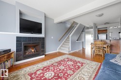 Hardwood-style flooring throughout, a tiled fireplace with mantel, and a built-in kitchen island - 