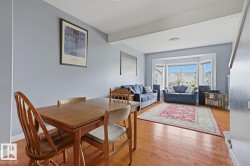 Hardwood flooring throughout, neutral wall tones, and a large bay window - 