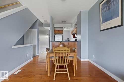 Hardwood-style flooring throughout - #9 13215 153 Av Nw, Edmonton, AB - Indoor Photo Showing Dining Room