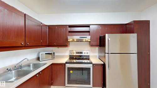 #109 11115 80 Av Nw, Edmonton, AB - Indoor Photo Showing Kitchen With Stainless Steel Kitchen With Double Sink