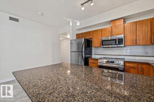 #118 10333 112 St Nw, Edmonton, AB - Indoor Photo Showing Kitchen With Stainless Steel Kitchen