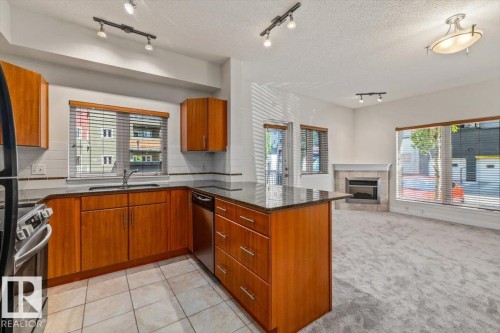#118 10333 112 St Nw, Edmonton, AB - Indoor Photo Showing Kitchen With Fireplace